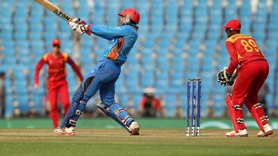 Afganistan's Mohammed Nabi plays a shot during the T20 World Cup cricket match between Zimbabwe and Afghanistan at the VCA stadium in Nagpur on March 12, 2016. / AFP / Prashant Bhoot