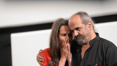 Ossama Mohammed comforts Wiam Simav Bedirxan, whose footage of the siege of the Syrian city of Homs inspired him to make “Silvered Water, Syria Self-Portrait” before the film’s screening at the Cannes Film Festival. AFP