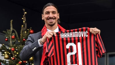 Zlatan Ibrahimovic poses with his new AC Milan jersey at the club's headquarters. EPA