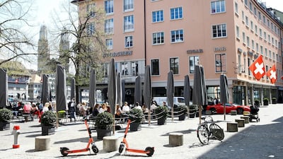 Guests enjoy the sunny weather as they sit in front of Hotel Storchen after the Swiss government allowed to reopen outdoor terraces in April. Reuters.