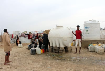 Yemenis fill jerricans with water from reservoirs at a make-shift camp for displaced people who fled fighting between the Huthi rebels and the Saudi-backed government, in the Abs district of the northwestern Hajjah province on January 23, 2020. Yemen's internationally recognised government, backed by a Saudi-led military coalition, has been battling the Iran-allied rebels since 2014, when they overran the capital Sanaa. / AFP / ESSA AHMED