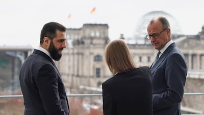 Mr Merz looks to the translator as he speaks to Mr Al Shara on the terrace ahead of their bilateral talks at the Chancellery. Reuters