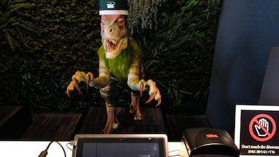 A robot dinosaur wearing a bellboy hat welcomes guests from the front desk at the Henn-na Hotel. AFP