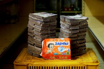A package of diapers is pictured next to 8,000,000 bolivars, its price and the equivalent of 1.22 USD, in Caracas, Venezuela August 16, 2018. Reuters
