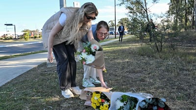 Members of the public place flowers by the road, 500 metres from the site of the accident. AFP