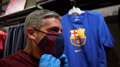 A man wearing a protective face mask poses during the presentation of official FC Barcelona brand masks. EPA