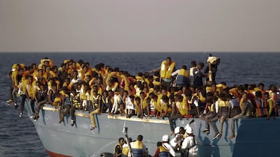 Migrants on an overcrowded wooden boat await rescue in the Mediterranean Sea, about 25km north of Sabratha , Libya August 29, 2016. Emilio Morenatti, / AP