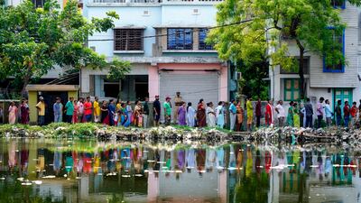 Voters queue outside a polling booth during the fifth round of the general election, in Howrah, West Bengal, in eastern India. AP