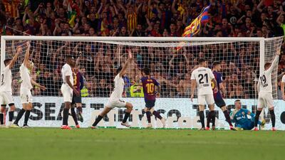 Messi, centre, runs to get the ball after scoring against Valencia. AP Photo