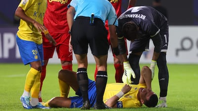 Persepolis goalkeeper Alireza Beiranvand checks on Al Nassr forward Cristiano Ronaldo following a collision. AFP