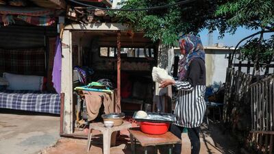 A woman kneads dough to make bread in Al Issifer Palestinian village south of Yatta town, in the occupied West Bank. AFP