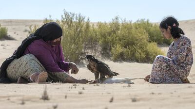 Osha assists her aunt, Afrah Al Mansoori, during a hunting trip. Vidhyaa Chandramohan for The National.