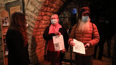 People present their coronavirus vaccination certificate at the entrance to the Khan Theatre in Jerusalem.