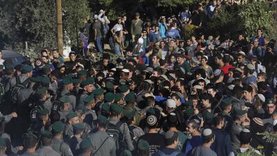 Israeli settlers scuffle with Israeli security forces at Netiv Haavot settlement. Menahem Kahana / AFP