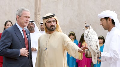 Sheikh Mohammed shows a falcon to US President George W Bush, during a visit to Dubai in 2008. AFP