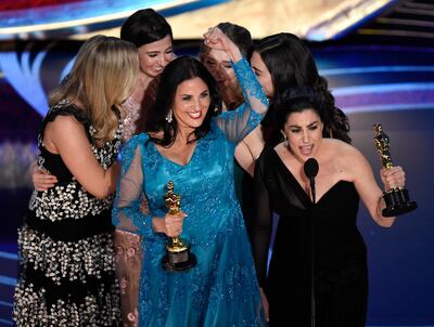 Melissa Berton, center left, and Rayka Zehtabchi accept the award for best documentary short subject for 'Period. End of Sentence.'