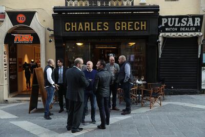VALLETTA, MALTA - MARCH 30: Local men stand outside a pub on March 30, 2017 in Valletta, Malta. Valletta, a fortfied town that dates back to the 16th century, is the capital of Malta and a UNESCO World Heritage Site. In the last 2,000 years Malta has been under Roman, Muslim, Norman, Knights of Malta, French and British rule before it became independent in 1964. Today Malta remains a crossroads of cultures and is a popular tourist destination. (Photo by Sean Gallup/Getty Images)