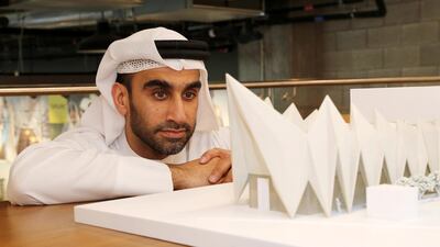 Ahmed Abdulrahman Bukhash, an Emirati architect with a model of the Expo Live pavilion at Expo 2020 Dubai. Pawan Singh / The National