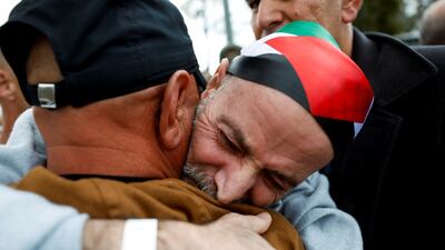 A freed Palestinian detainee is hugged in Ramallah. Reuters