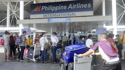 Passengers enter the Philippine Airlines passenger terminal at Manila airport. Two local billionaires have offered to build a new hub for the capital. AFP Jay Directo / AFP