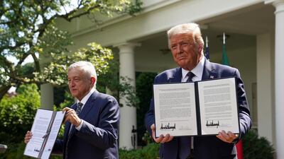 US President Donald Trump holds a joint declaration he signed with Mexico's President Andres Manuel Lopez Obrador in the Rose Garden at the White House in Washington, US. Reuters