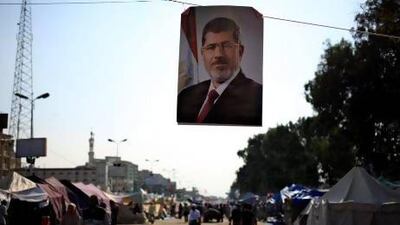 Both the Muslim Brotherhood and opposition movement that toppled Mohammed Morsi, pictured in this banner, have called for more rallies today.