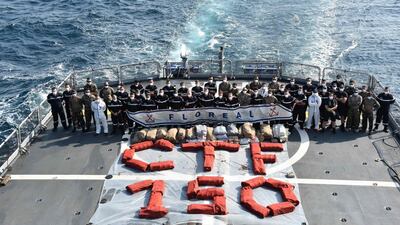 The crew of the French frigate Floreal posing next to bags of drugs captured from a suspicious vessel as part of a counter-narcotics operation in the Northern Indian Ocean. AFP