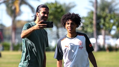 Manchester City's Rico Lewis with a fan at the Emirates Palace.
