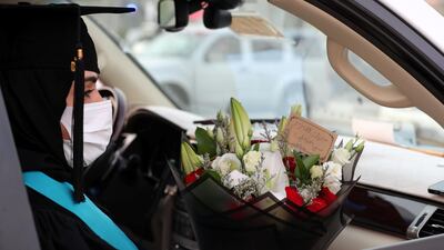 Afra Mohammed waits in her car before her drive-through graduation from Ajman University.