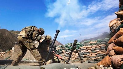 Private First Class Trent Pritchartt (L), Specialist Lance Doan (C), and Specialist Ben Purvis from the mortar platoon on Combat Outpost Nangalam fire 81mm mortar rounds at suspected insurgent positions in the Pech River Valley of Afghanistan's Kunar Province June 28, 2012. REUTERS/Lucas Jackson