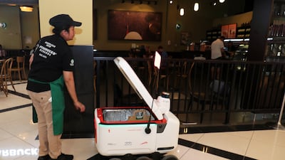 A delivery robot picking up an order from Starbucks in Dubai. All photos: Pawan Singh / The National