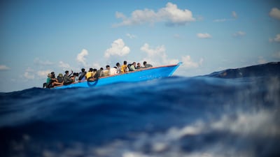 Migrants in a wooden boat south of the Italian island of Lampedusa in the Mediterranean, in August 2022. AP