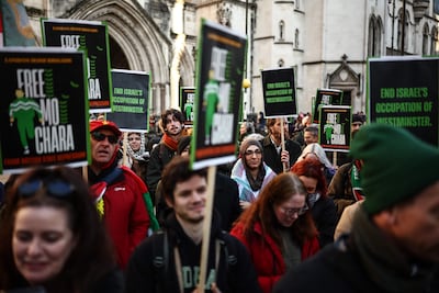 Supporters of Irish rap group Kneecap protest outside the Royal Courts of Justice. AFP