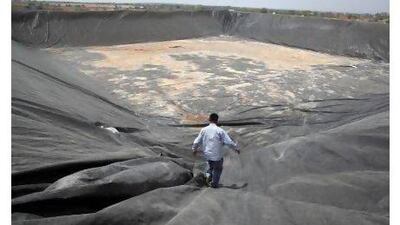 Pomegranate farmer Rajaram Yelpale inspects a temporary water reservoir in Ajnale in the Solapur district of Maharashtra, one of the worst drought affected areas. Subhash Sharma for The National