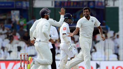 Ravichandran Ashwin, right, hit a half century with the bat before taking the two Sri Lanka wickets on Day 2 in Colombo. Lakruwan Wanniarachici / AFP