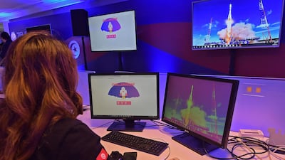 An employee of Tunisia's Telnet telecommunications group watches the launch of Russia's Soyuz-2.1a carrier rocket from the Baikonur cosmodrome. AFP