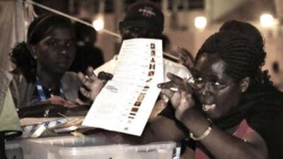 An Angolan polling station agent signals a vote on a cast ballot as they start counting at a polling station in Samba, downtown Luanda on September 6, 2008. Over eight million Angolans voted yesterday to elect the parliament for the second time since their independence from Portugal in 11 September 1975.