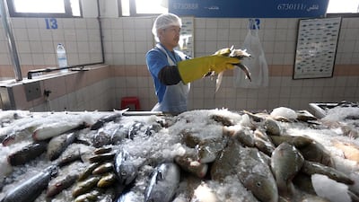 Experts say fish, here for sale at the Abu Dhabi fish market, and chicken are viable alternatives to red meat when considering dietary changes. Sammy Dallal / The National