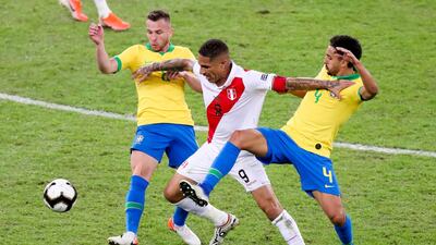 Peru's Paolo Guerrero goes for the ball with Brazil players Marquinho, right, and Arthur. AP Photo