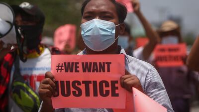 A demonstrator holds a placard during an anti-military coup protest in Mandalay, Myanmar. EPA