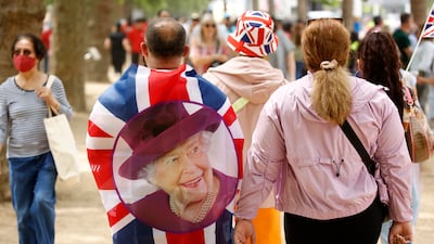 People walk along The Mall, outside Buckingham Palace on the second day of celebrations. AP Photo