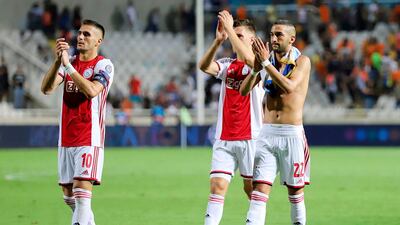 Ajax players players appluad supporters at the final whistle. AFP