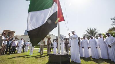 The flag is raised by HE Mohamed Ebraheem Al Mahmood, Abu Dhabi Media Chairman and Managing Director, with executive management in attendance. Mona Al Marzooqi / The National