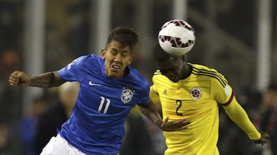 Roberto Firmino, left, will "move to England" but it is unclear to which club. Henry Romero / Reuters