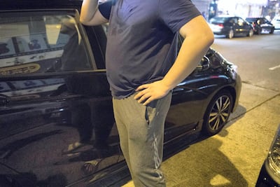 'John' (not his real name), a school bus driver, speaks on the phone to locate Georgina in the Mong Kok district of Hong Kong before driving her safely home from the protests. Rick Findler for The National