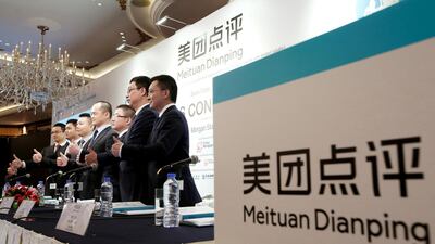 Management of China's Meituan Dianping, an online food delivery-to-ticketing services platform, attending a news conference in Hong Kong. Reuters