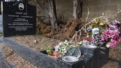 Fragments of bone on top of a grave in Tottenham Park Cemetery. Locals believe graves are being dug up and reused without family permission. Gareth Browne / The National