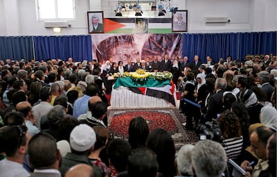People gather around the coffin of Mahmoud Darwish during his funeral in Ramallah, on August 13, 2008. EPA
