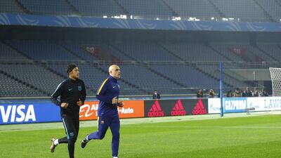 Barcelona’s Neymar, left, and a member of his team’s staff run during a training session on Wednesday in Japan. Shizuo Kambayashi / AP