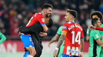 Girona goalscorer Ivan Martin, left, celebrates with teammates after the match. EPA